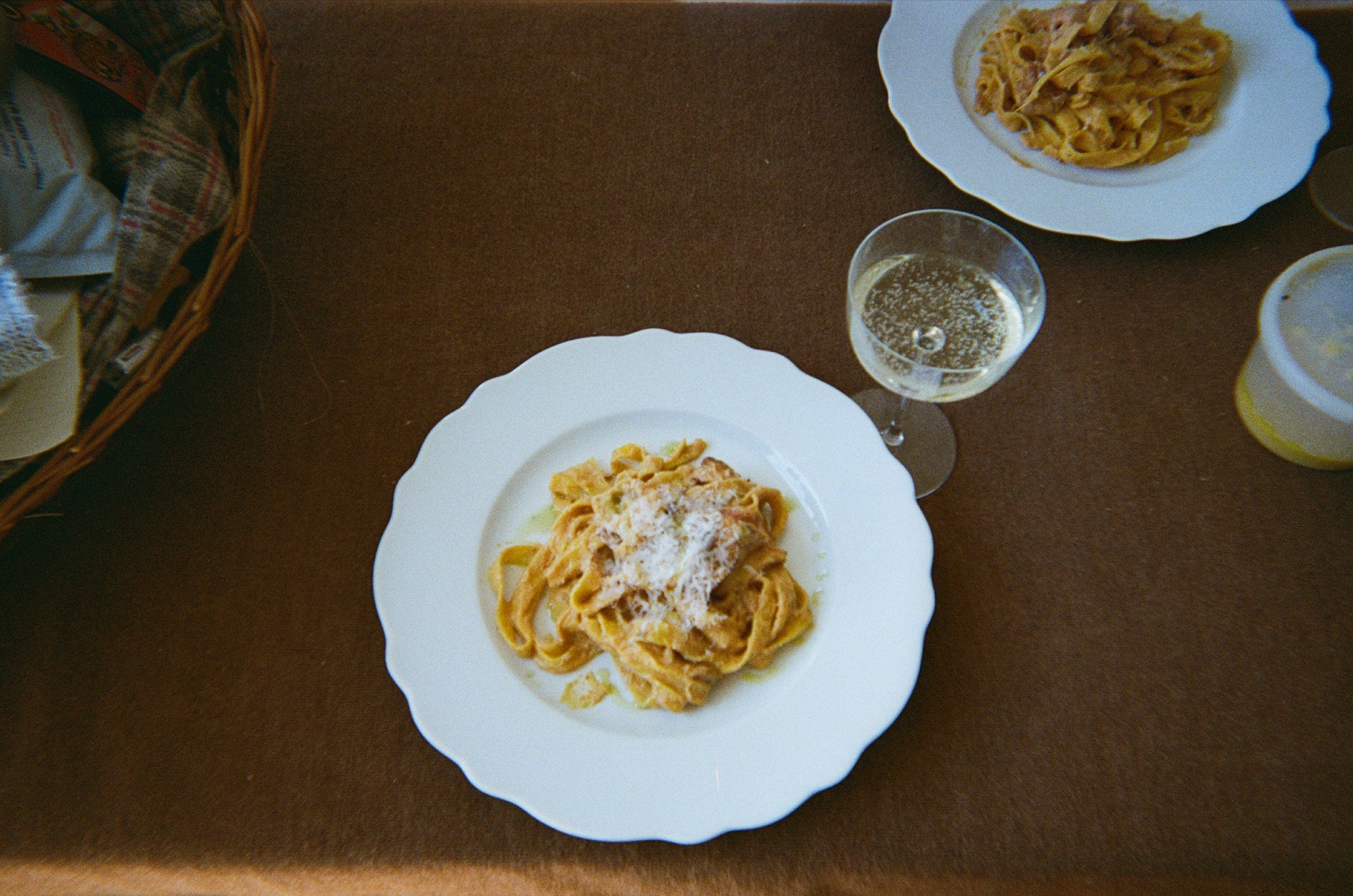 Pasta plates and a glass of wine on a table